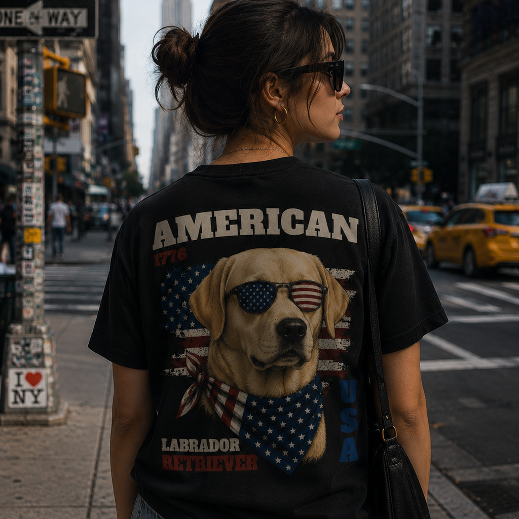 Person wearing a black t-shirt with a dog graphic and 'American' text on a city street.