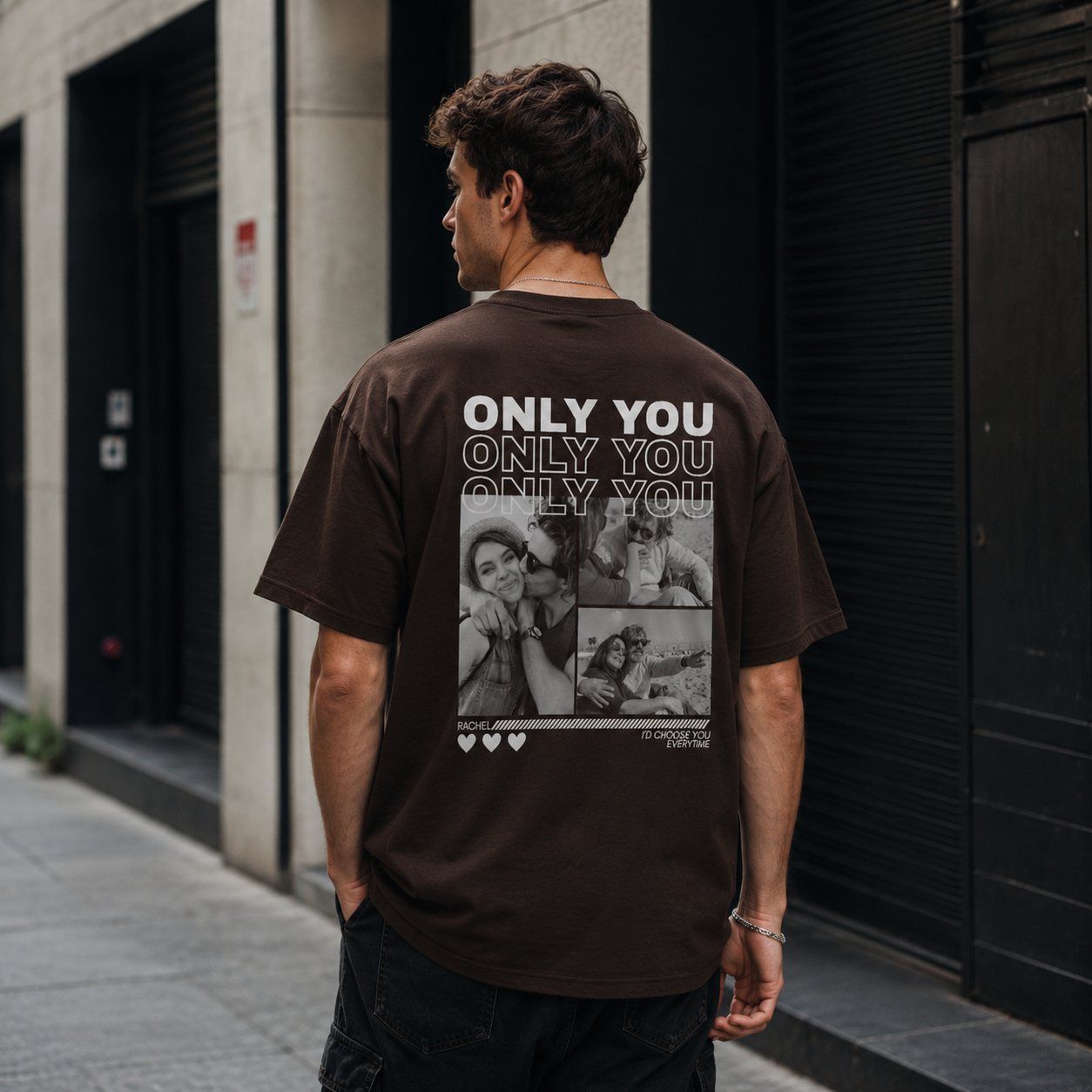 Man wearing a brown t-shirt with 'Only You' text and collage design, standing on a street.