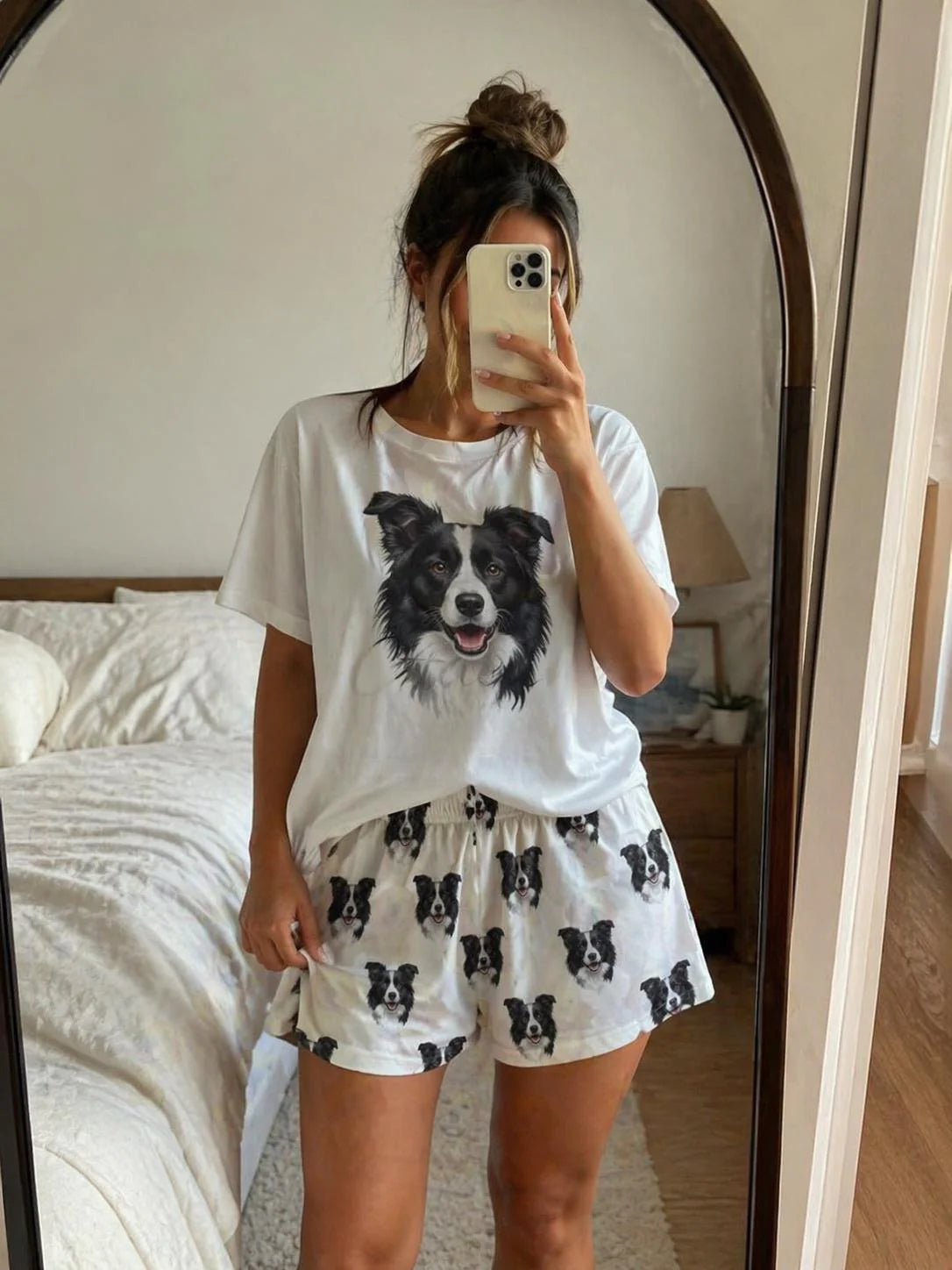 Person wearing a white t-shirt with a dog graphic and matching shorts in a bedroom.