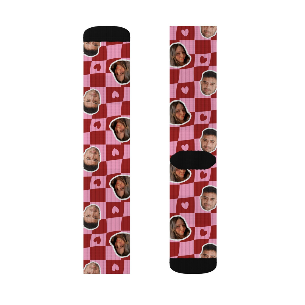 Two socks with a checkered pattern and face images on a white background