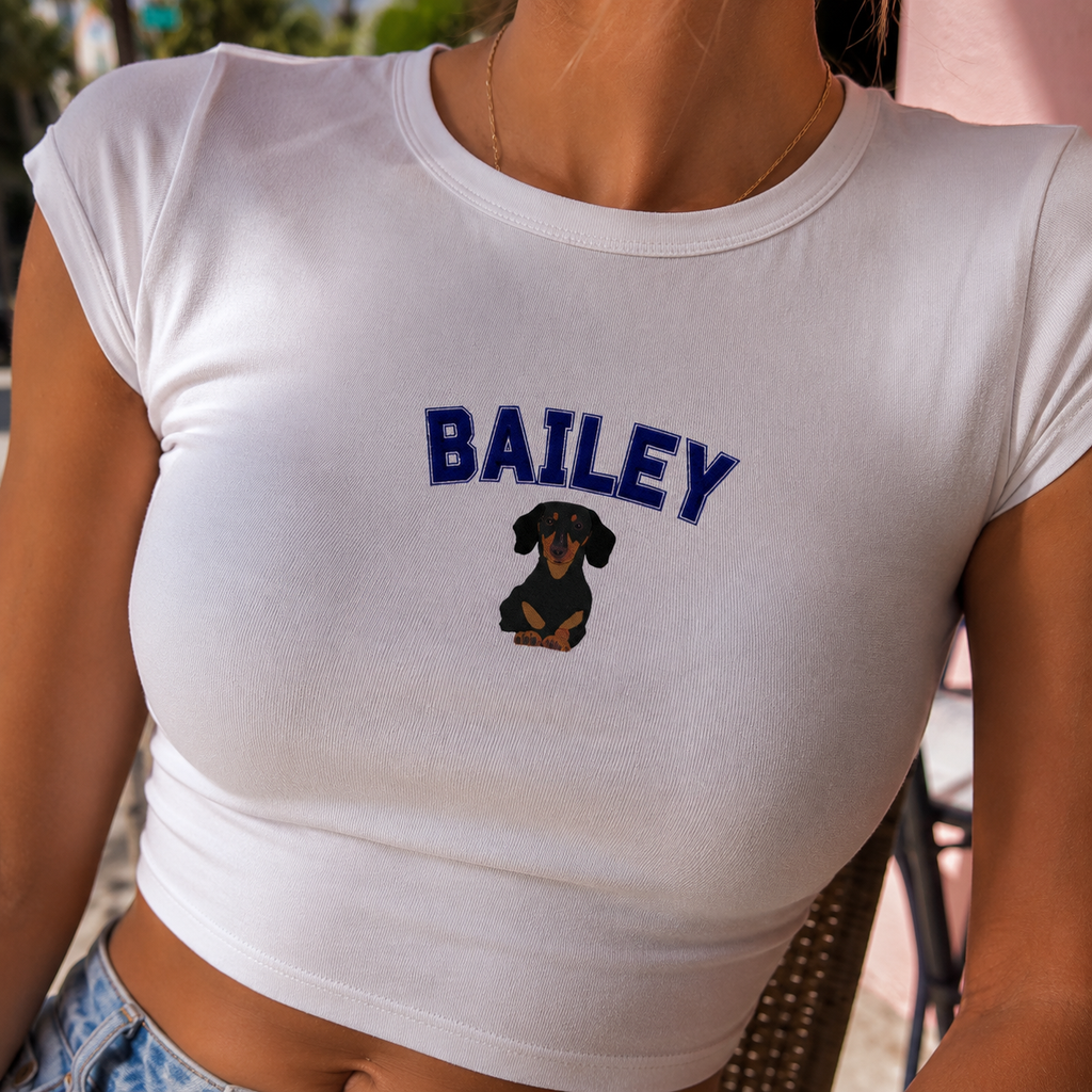 White t-shirt with 'BAILEY' and a dog graphic, worn by a person.