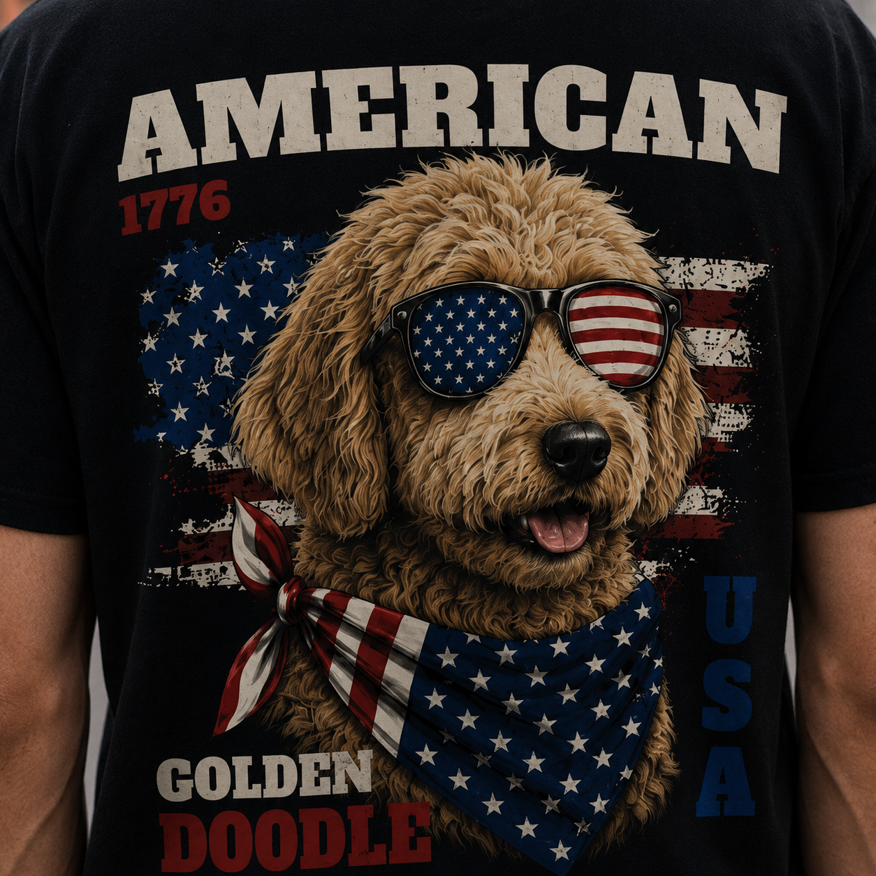 T-shirt with a dog wearing sunglasses and an American flag bandana, text 'American 1776 Golden Doodle USA' on a black background.