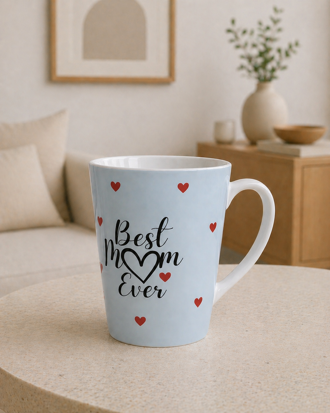 Light blue mug with 'Best Mom Ever' text and red hearts on a beige surface.