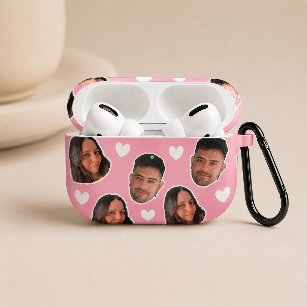 Pink AirPods case with cutout faces and heart patterns on a beige background