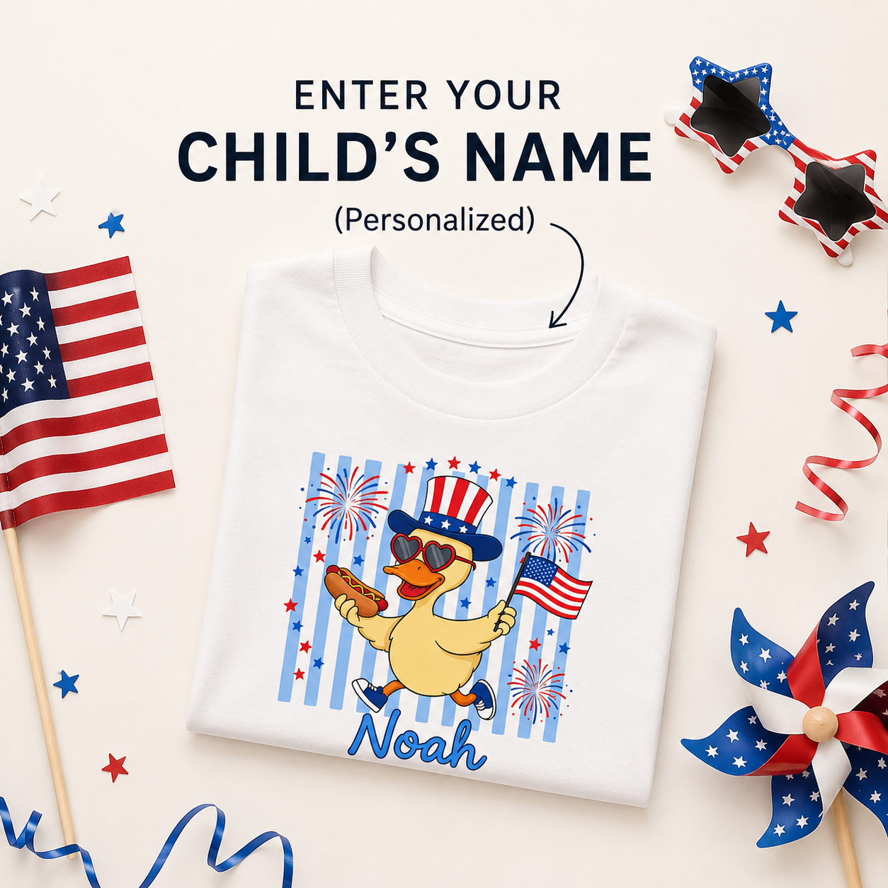 White t-shirt with a duck wearing an American flag hat and sunglasses, surrounded by patriotic decorations.